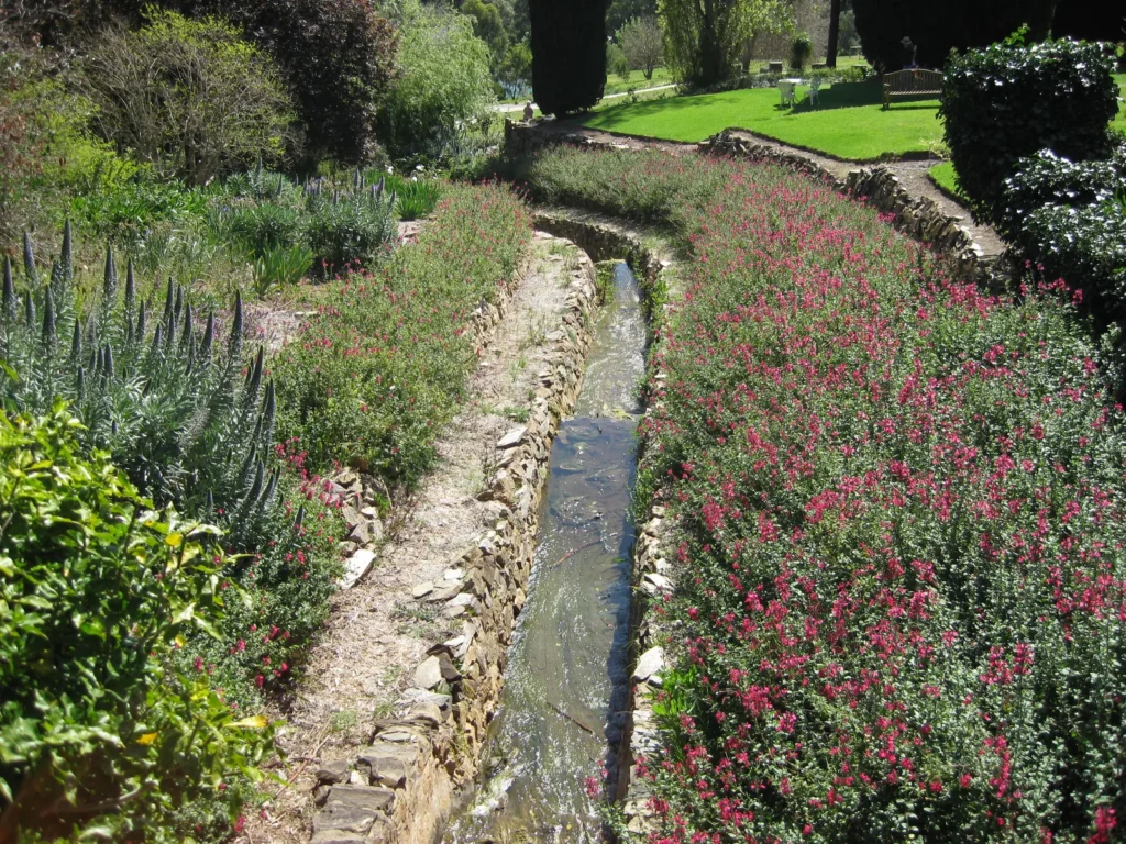 Narrow stone rill running between flower beds in the Carrick Hill gardens